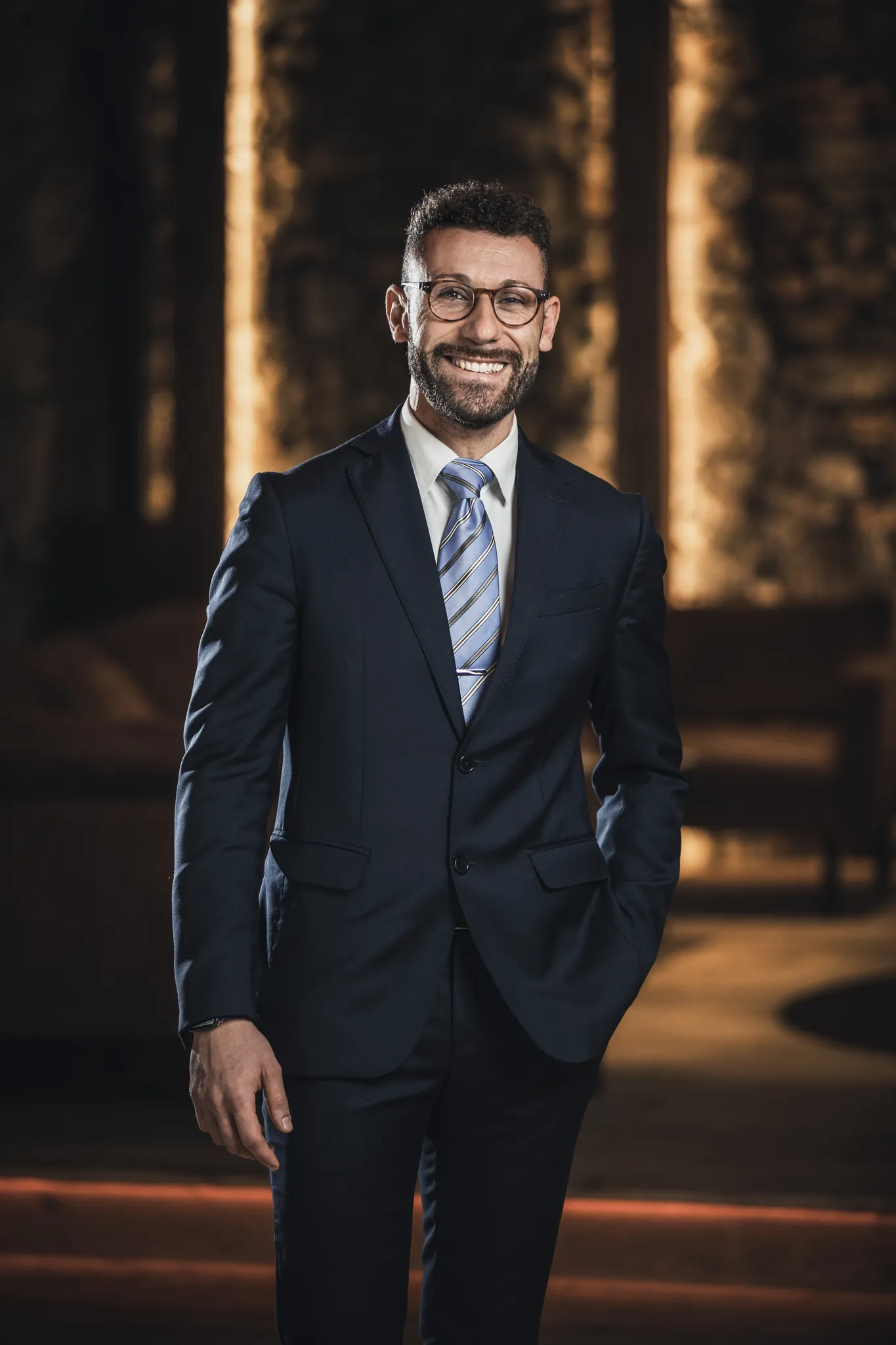 Mann im Anzug vor warmem Holzinterieur, Business Portrait